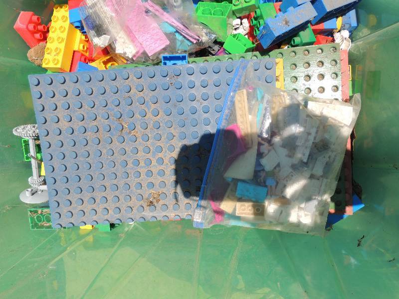 lot 185 image: Green tub of Legos and Kids shovels...