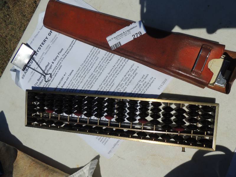 lot 279 image: Abacus and slide rule in leather ca...