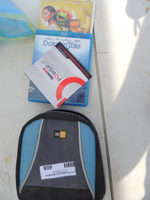 lot 408 image: CD case with movies (Wizard of Oz, ...