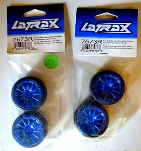 lot 27 image: NEWSEALED - Traxxas 7573R - LaTrax Slick Tires, 12-Spoke Wheels, Blue Chrome (4)