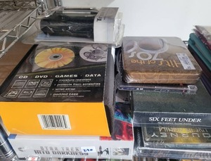 lot 290 image: NEW DVD HOLDER, DVDS, AND MORE.