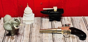 lot 142 image: Four Avon Collectible Cologne Bottles - Thomas Jefferson Handgun, Hammer and Anvil, Milk Glass Capitol Building, &amp Majestic Elephant&nbsp