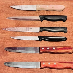 lot 243 image: Two Tramontina 10 inch Wood Handle Serrated Edge Stainless Steel Knives Brazil, 8-12 Ginsu 2000 Serrated Black Handle Stainless Utility Knife, &amp Four Other Quality Knives