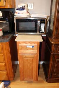 lot 45 image: Microwave and Stand (Stand has cutting board for top, Microwave Browner Grill, Paper Plates)