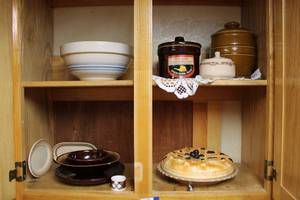 lot 57 image: Covered Fruit Pie Plate, Pottery Bread Bowl, Brown Jars and dishes