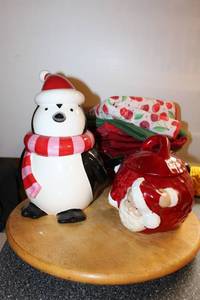 lot 64 image: Penguin Coffee jar, Ceramic Santa lidded jar, Wooden lazy susan, Glass Bowl and towels