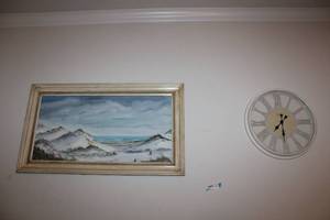 lot 86 image: Ocean shore artwork with antiqued frame and wall clock