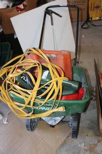 lot 305 image: Scotts yard spreader, Hedge trimmer with extension cord, gas can