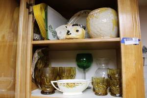 lot 52 image: Vintage Amber Glassware, Green glass goblet, Cookie Jar, Plastic Paper Plate Holders, and Gravy Boat