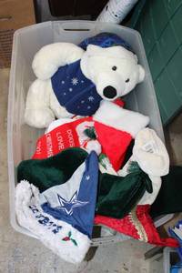 lot 25 image: Large Plush Christmas bear, Dallas Cowboys Santa hat and Christmas stockings (most still have tags) Includes Rubbermaid tote