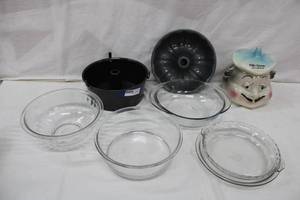 lot 41 image: Vintage Petits Gateaux Cookie jar, Clear Pyrex mixing bowls and pie plates, Bundt pan and angel food cake pan look unused