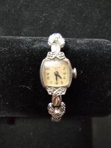 lot 85 image: Bulova 23 (L9) 10KT rolled gold and diamond watch face with diamond adorned flexible watch band. 6 diamonds total. Diamonds tested.