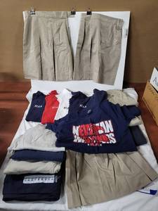 lot 172 image: School uniforms - shirts are for Newman Intl Academy includes pants, skirts and shorts as shown