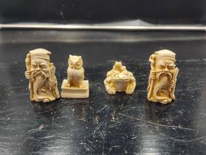 lot 33 image: Selection of 4 hand carved resin Netsuke figures