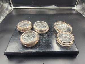 lot 37 image: Total of 11 glass and silver coasters.  are made by Rogers 1883