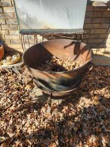 lot 367 image: Large cast iron pot and stand in backyard