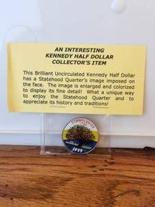 lot 130 image: 1999 - interesting Kennedy Half-Dollar collectors coin - statehood quarters image imposed on face