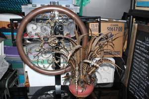 lot 43 image: Metal Wall Decor and Potted Arrangement with Pheasant Feathers as shown in pictures