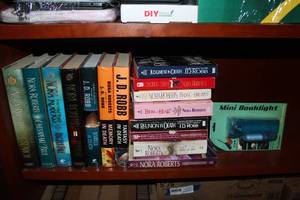 lot 96 image: Nora Roberts and JD Robb Books Pictured As Shown and Mini Book light
