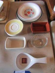 lot 28 image: 2 butter dishes from Garden ridge, yellow saucers qty 5, spoon rest, winter plate