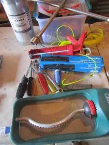 lot 42 image: Misc. tool lot includes, tire tool, cocking gun, weed eater string, screw drivers and more