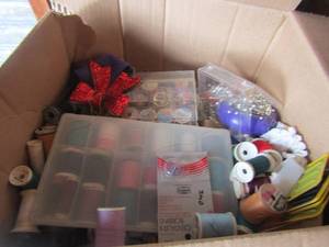 lot 107 image: Box full of seweing items large amounts of string new and used, needles and thread plus much more not pictured. Multi colors