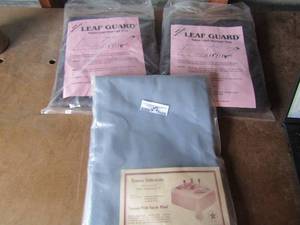 lot 109 image: New pack of Leaf Guard storage bag qty 2, brown leather---- Ventura table cloth By Tara handcrafts 50%cotton- 50% polyester, size 6084 NIP