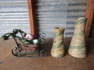 lot 118 image: Metal and wooden sleigh with snowman riding inside, decorated with Christmas greenery, 6115---  2 glass tile like candle stands matching  sizes are biggest 10 Smallest is 7 14