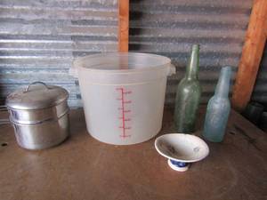 lot 122 image: 12 liter clear double handled bucket, covered stem pan, blue vintage glass bottle 9 34, green vintage glass bottle 12 inches