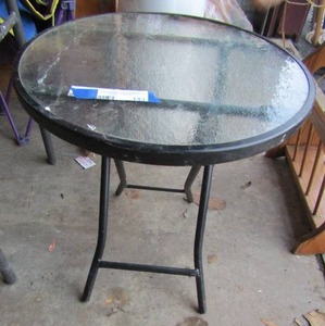 lot 143 image: Foldable glass top outdoor patio table, good condition-- 1918