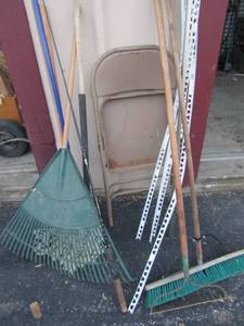 lot 144 image: Rakes, mop, sticks and a push broom and a fold up metal chair