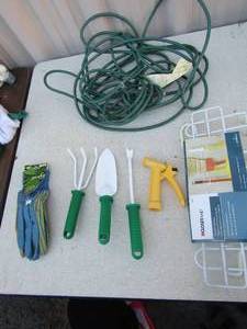 lot 190 image: 10ft green extension cord, new closet maid for hanging brooms racks and mops, small gardening tools, new pair of weeding gloves size medium