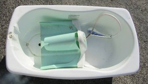 lot 63 image: Baby bath with sprayer in tub Light colors