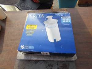 lot 84 image: Brita filters pack of 10, works on 40 gal tank lasts up to 2 months, various used baking sheets, cookie sheets,