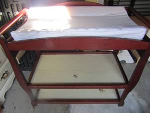 lot 153 image: Baby changing table 3 tier with pad for comfort on top, needs cleaned it is dark cherry wood color finish, all in used condition