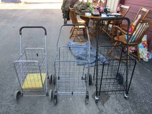 lot 74 image: Folding grocery shopping carts, rolling all fold up for storage qty 3, 1 silver and 2 are black