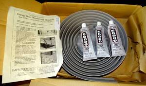 lot 216 image: NEW - GARAGE DOOR WEATHER SEAL GRAY WITH ADHESIVE - IN BOX WITH DIRECTIONS