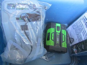 lot 28 image: Go Pro 56 V ARC lithium battery comes with a new charger and paper work, sold as battery and charger only