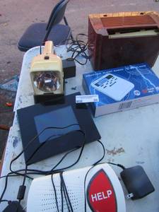 lot 50 image: Alert Help machine with knecklace for east push, New weather alert radio, electric spotlight flash light, Digital alarm clock