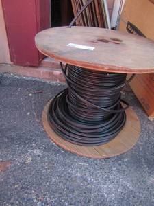 lot 56 image: Small Roll of used electrical wire, black unknown use for