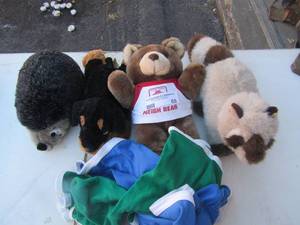 lot 69 image: Stuffed animals , state farm insurance bear, doggies, 2 puppy outfits