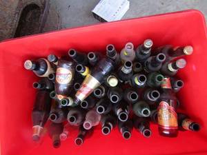 lot 163 image: Red tote holds various types of beer bottles, jack daniels, coors, mississippi mud, samuel adams and more