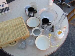 lot 186 image: Kitchen lot includes, 2 glass pie plates, misc. coffee cups, 1 single flower vase, bowls, and a wicker style pic-Nic basket empty