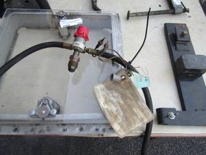 lot 205 image: 1 black jack stand, cabin window qty 1, some sort of hitch hook, gas or air hose part # 3132759