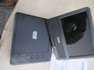 lot 211 image: Sylvania swivel screen portable DVD player, perfect for your ride in car with small children, comes ewith plug and paper work