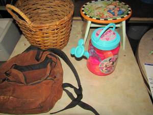 lot 219 image: Misc. lot includes, New mickey mouse sand play set, small peter rabbit foot stool wooden, brown smaller back pack, dB handled wicker basket