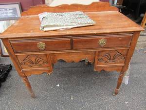 lot 223 image: Vintage wooden rolling desk one wheel is missing needs some tlc