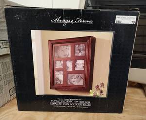 lot 15 image: HANGING PHOTO JEWELRY BOX IN BOX AS SHOWN. MEASURES APPROX. 14 W x 2.5 D x 16 H.