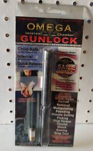 lot 156 image: OMEGA INTERNAL CHAMBER GUN LOCK IN PACKAGE AS SHOWN.