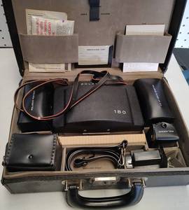lot 337 image: VINTAGE 1960S POLAROID LAND CAMERA WITH CASE AND ACCESSORIES AS SHOWN. SEARCH IT UP